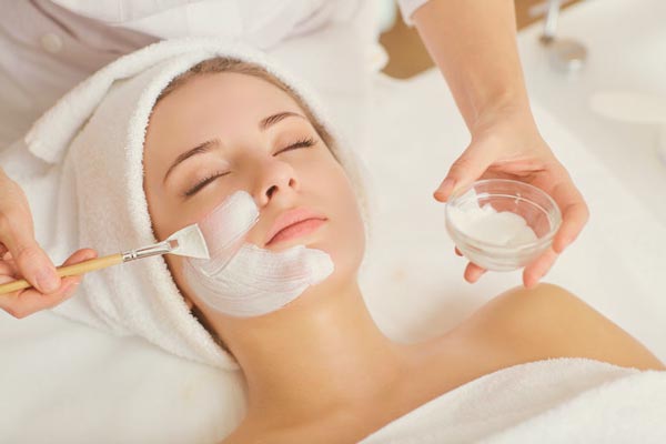 client receiving facial cleansing treatment