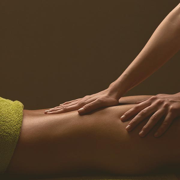 massage practitioner providing back massage treatment